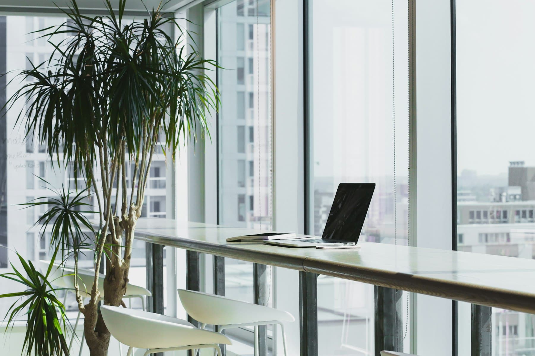 Bright office interior with large windows and a work ledge