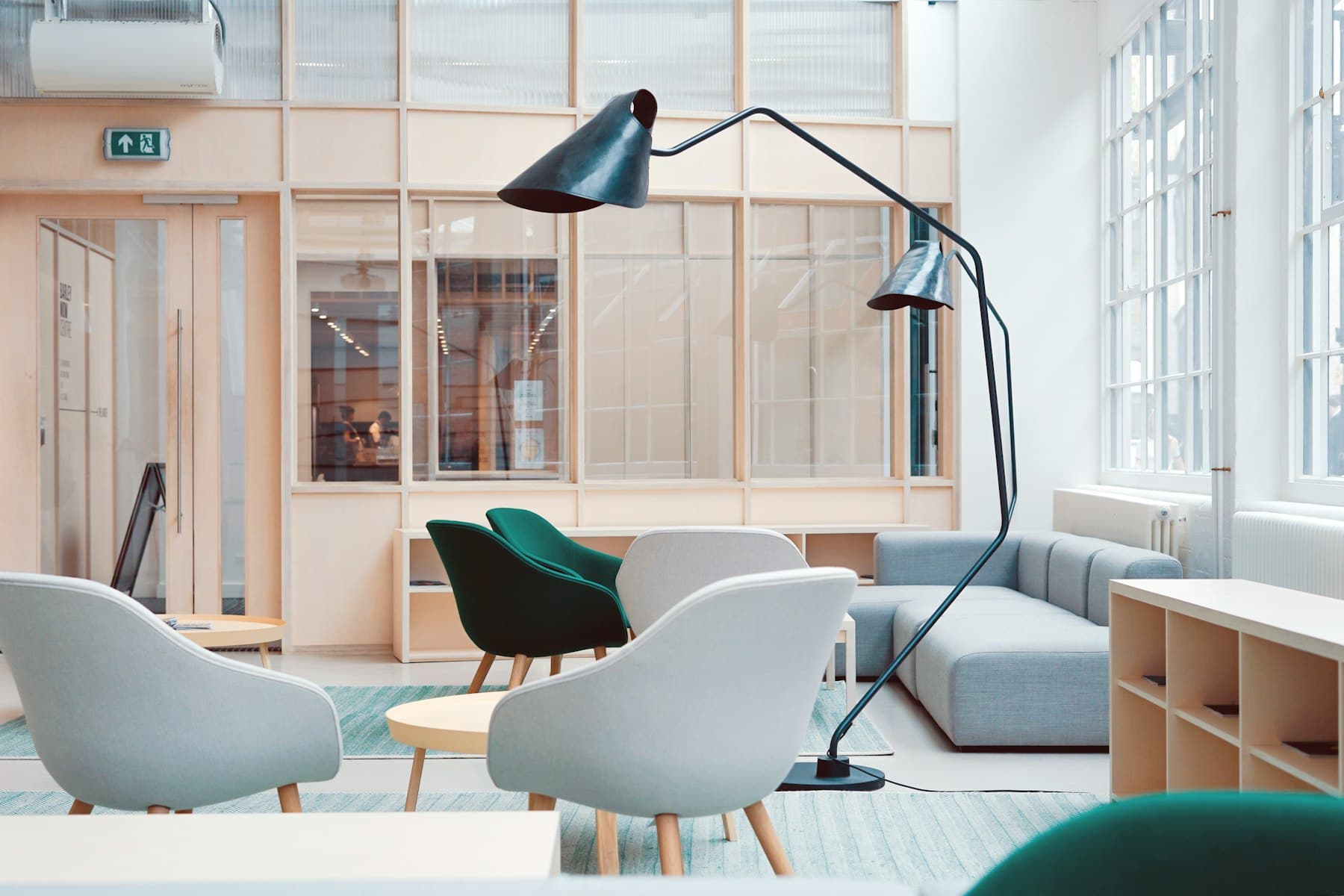 Commercial common-area lounge with seating and large windows